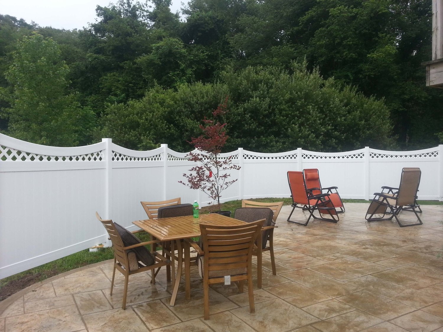 White vinyl privacy fence around a backyard patio
